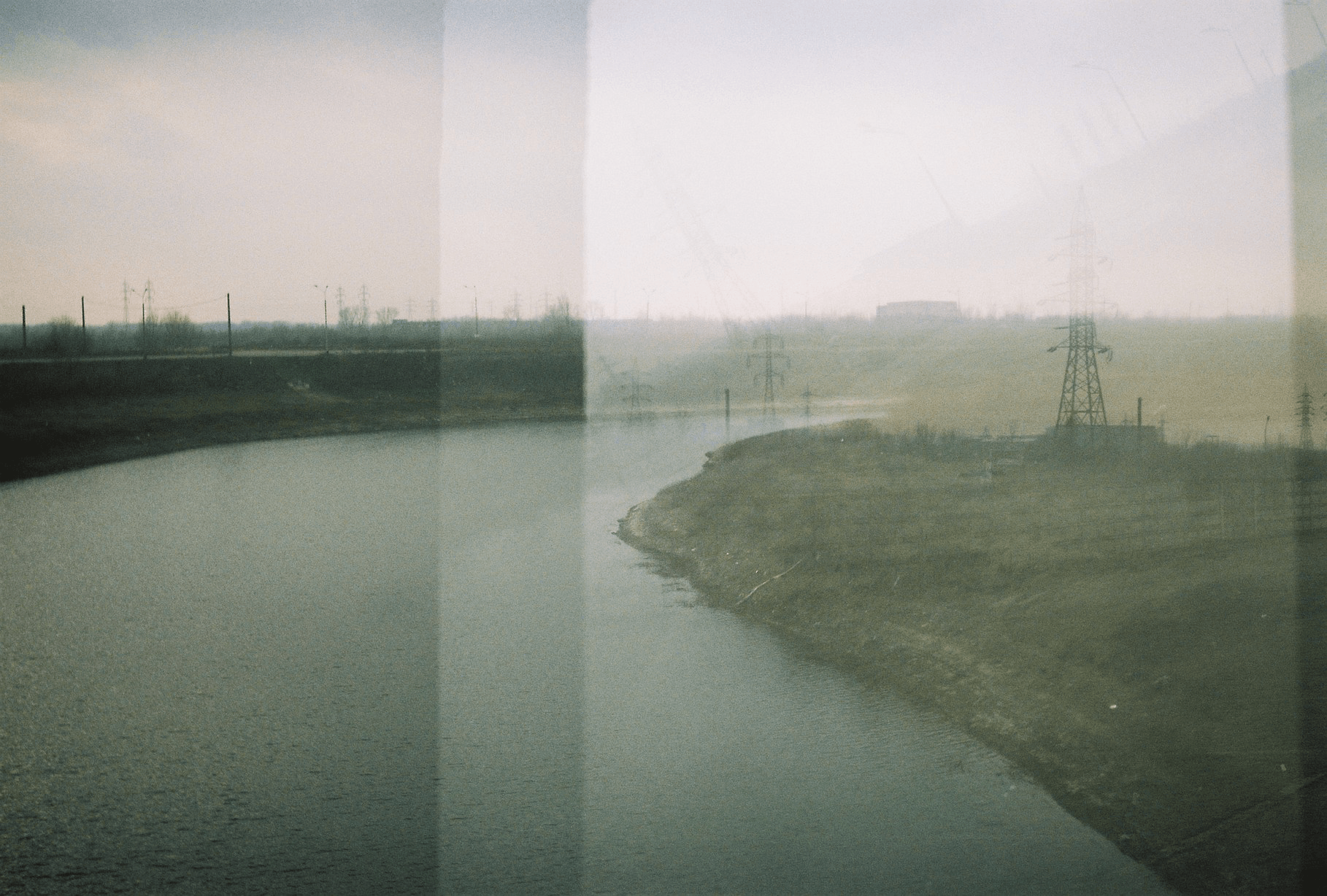 Photo of foggy field, with film artefacts, prominent grain, with an eery feel.